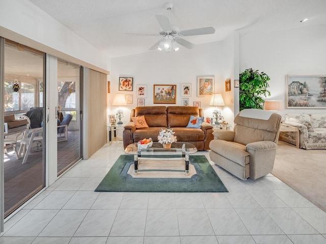 living room with lofted ceiling, light carpet, light tile patterned flooring, and ceiling fan