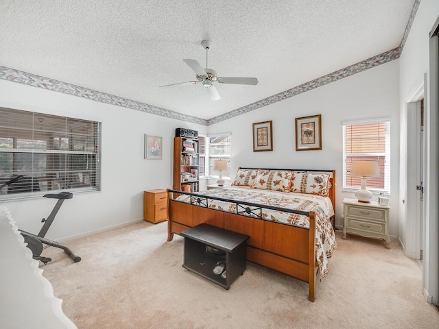 bedroom featuring multiple windows, a textured ceiling, light carpet, and vaulted ceiling