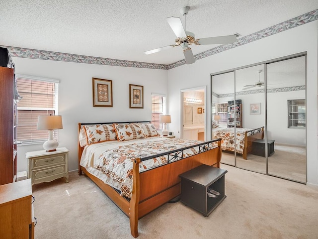 bedroom featuring a closet, carpet flooring, a textured ceiling, and ceiling fan