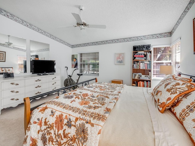 bedroom with carpet floors, a textured ceiling, and ceiling fan