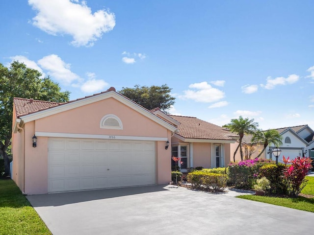 ranch-style home featuring stucco siding, driveway, and a tiled roof