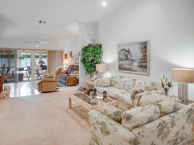 carpeted living area featuring visible vents, a ceiling fan, and vaulted ceiling