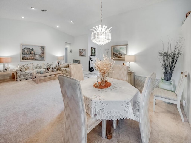 dining area with visible vents, light carpet, lofted ceiling, and an inviting chandelier