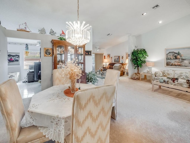 dining room featuring visible vents, vaulted ceiling, light carpet, ceiling fan with notable chandelier, and recessed lighting