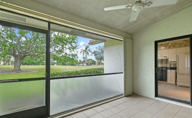 unfurnished sunroom with lofted ceiling and ceiling fan