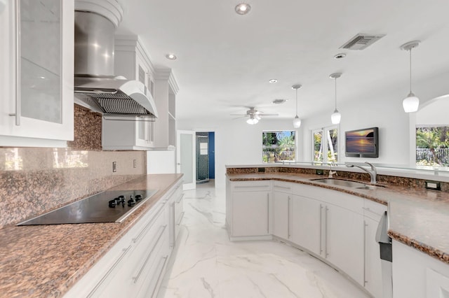 kitchen featuring visible vents, black electric stovetop, range hood, a ceiling fan, and a sink