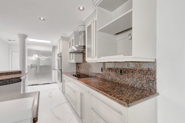 kitchen featuring tasteful backsplash, stainless steel appliances, marble finish floor, white cabinetry, and wall chimney exhaust hood