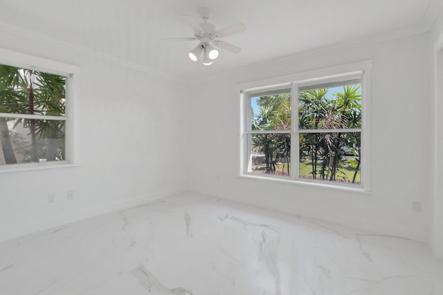 unfurnished room with crown molding, a ceiling fan, marble finish floor, and baseboards