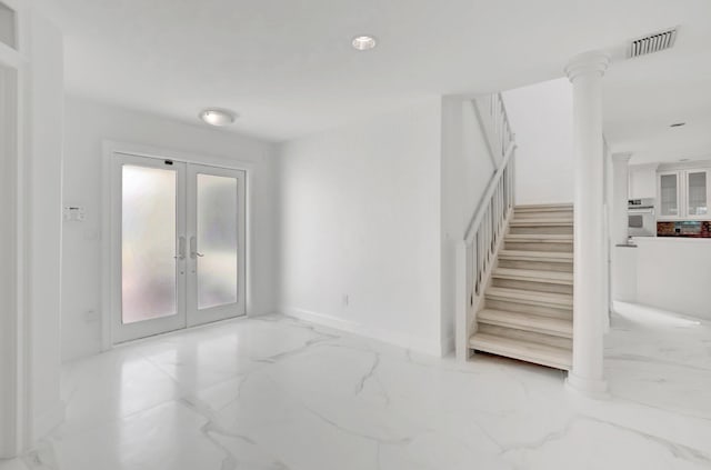 interior space with visible vents, marble finish floor, french doors, and baseboards