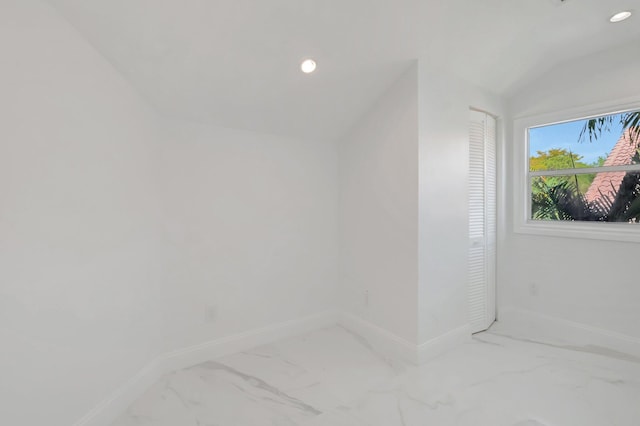 interior space featuring recessed lighting, marble finish floor, baseboards, and vaulted ceiling