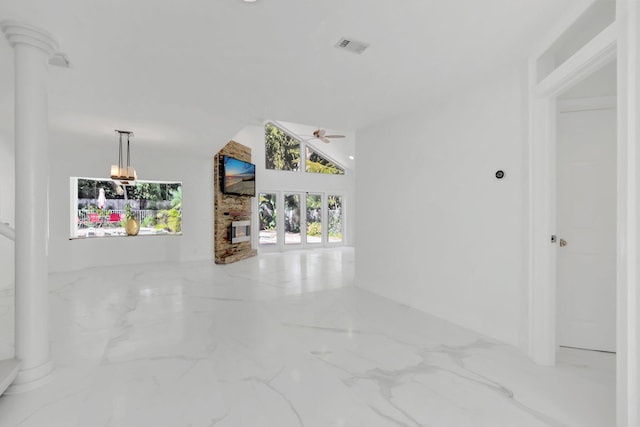 hallway with lofted ceiling, visible vents, and marble finish floor