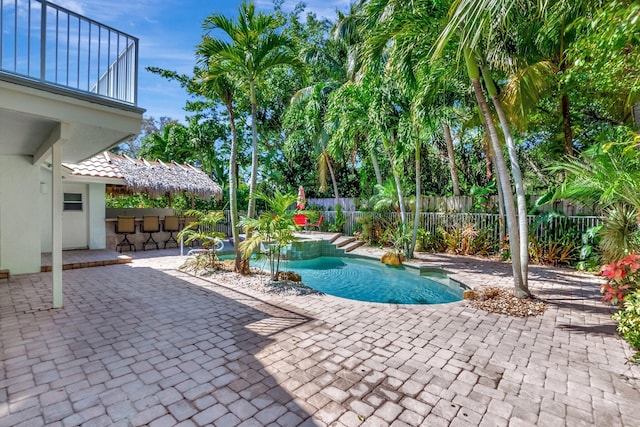 view of swimming pool featuring a fenced in pool, a fenced backyard, outdoor dry bar, and a patio area