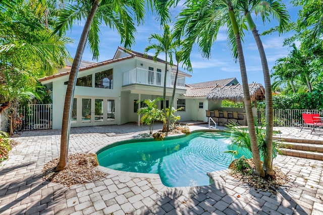 view of swimming pool with french doors, fence, a fenced in pool, and a patio area