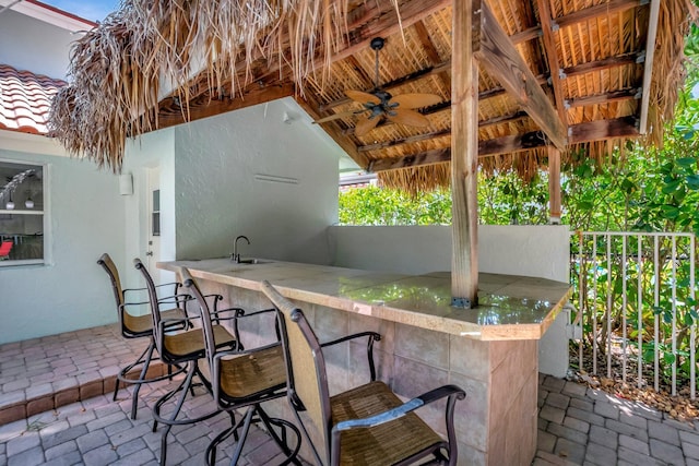 view of patio / terrace with a sink, outdoor wet bar, and ceiling fan