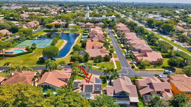 drone / aerial view featuring a residential view and a water view