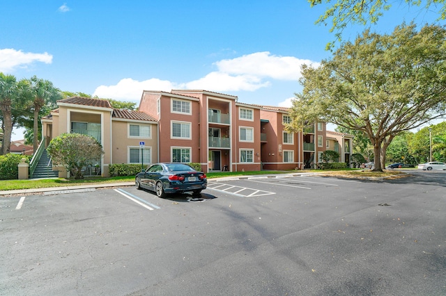 view of property featuring uncovered parking