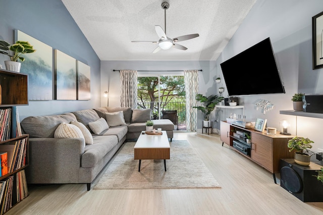 living area with light wood-style flooring, lofted ceiling, a textured ceiling, and ceiling fan