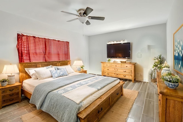 bedroom featuring wood tiled floor, baseboards, and ceiling fan