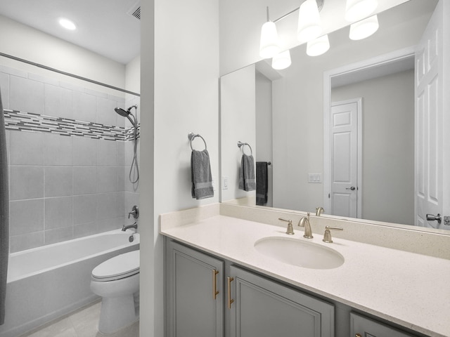 bathroom featuring visible vents, toilet, vanity, and shower / washtub combination