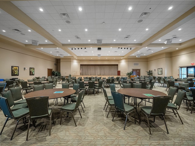 dining room with light colored carpet, visible vents, a towering ceiling, and recessed lighting