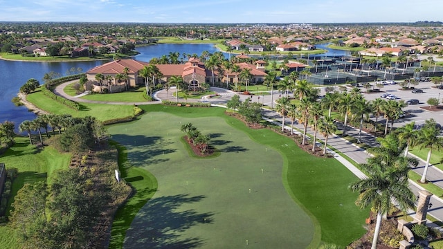 birds eye view of property featuring view of golf course, a residential view, and a water view