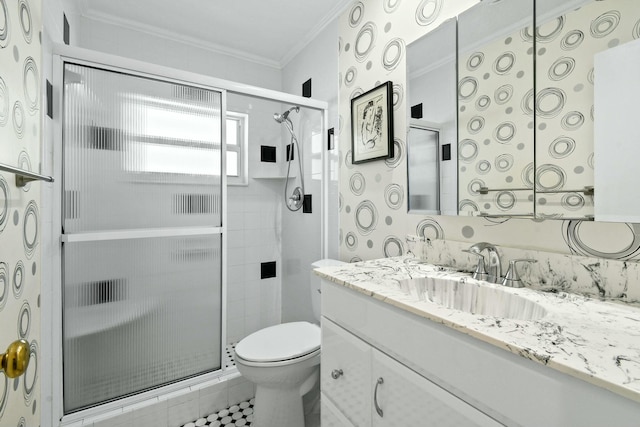 bathroom featuring vanity, toilet, a stall shower, and ornamental molding