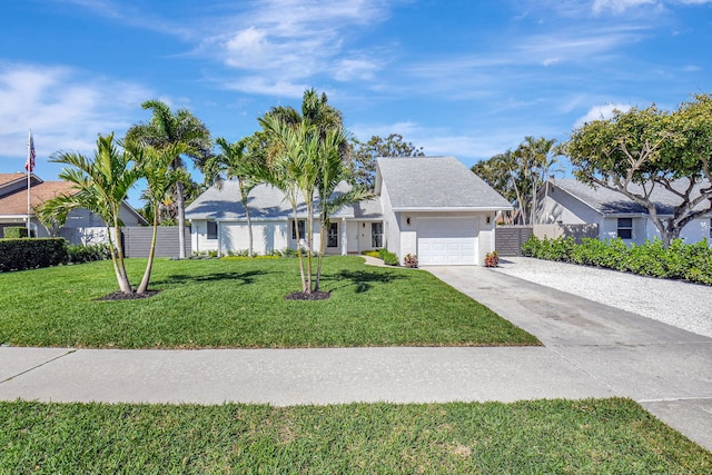 ranch-style home with a front yard, fence, a garage, and driveway