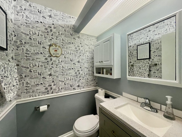 bathroom with toilet and vanity