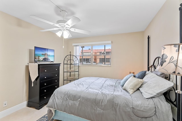 bedroom with a ceiling fan and baseboards