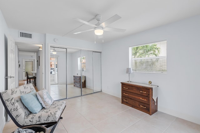 sitting room with light tile patterned flooring, baseboards, visible vents, and ceiling fan