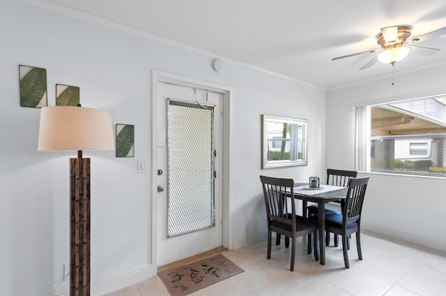 dining space featuring crown molding, a ceiling fan, and baseboards