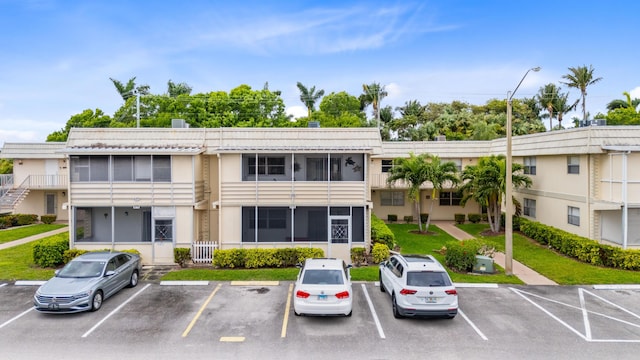 view of property featuring uncovered parking