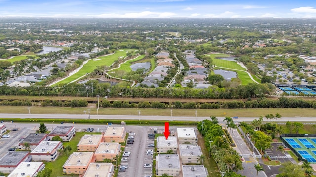 bird's eye view with a water view and view of golf course