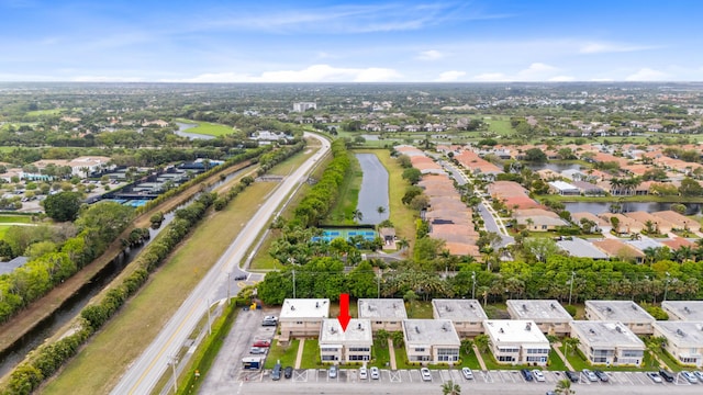 drone / aerial view with a water view and a residential view