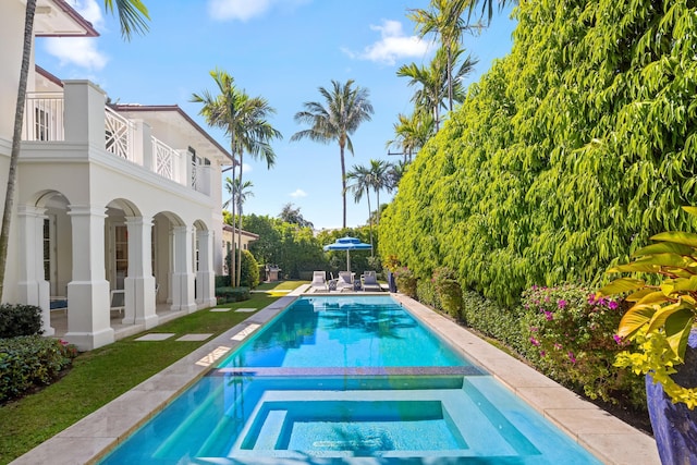 view of swimming pool with a patio and a pool with connected hot tub