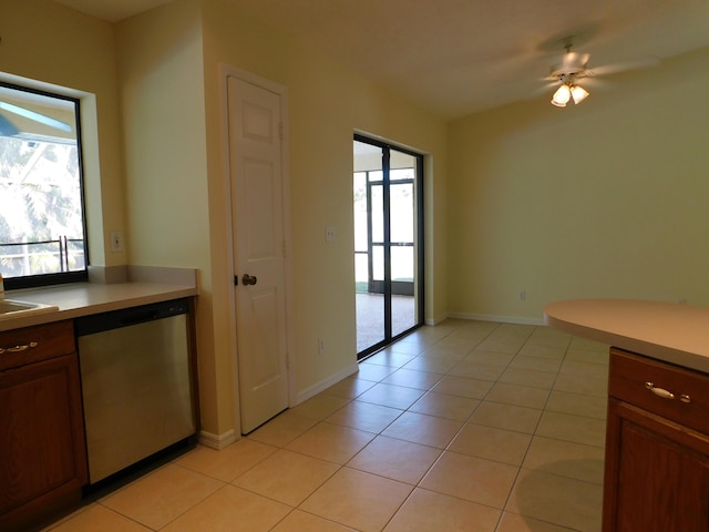 kitchen with dishwasher, light countertops, light tile patterned floors, and a wealth of natural light