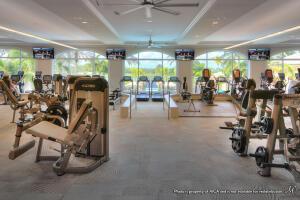 exercise room featuring a healthy amount of sunlight and ceiling fan