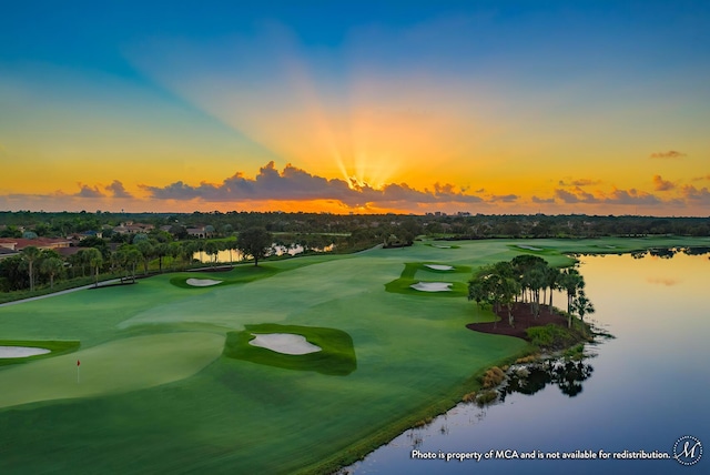 view of home's community featuring view of golf course and a water view