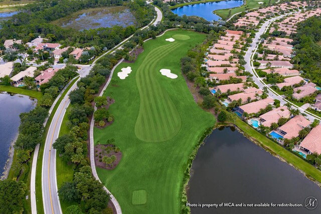 aerial view featuring a water view and golf course view