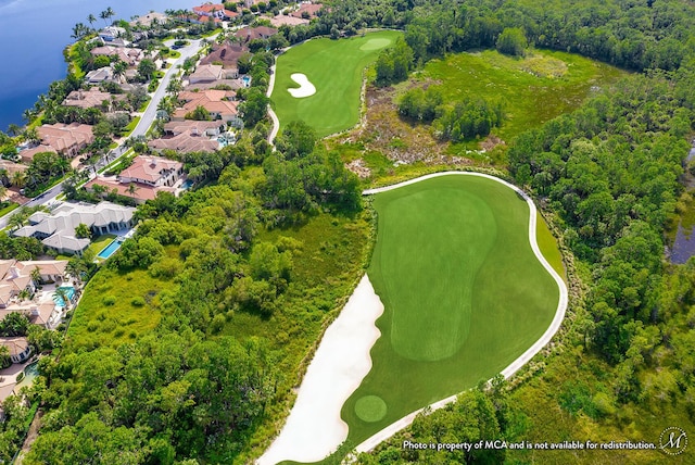 birds eye view of property with golf course view, a residential view, and a water view