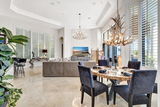 dining area featuring visible vents, crown molding, an inviting chandelier, arched walkways, and a raised ceiling