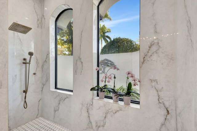 interior space with a marble finish shower