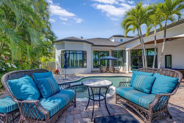 view of patio / terrace with outdoor dining area, a ceiling fan, fence, and an outdoor hangout area