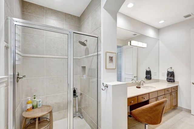 bathroom featuring tile patterned flooring, visible vents, recessed lighting, a stall shower, and vanity