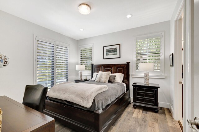 bedroom featuring recessed lighting, light wood-type flooring, and baseboards