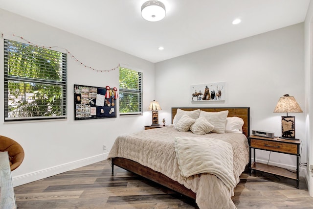 bedroom with recessed lighting, baseboards, and wood finished floors