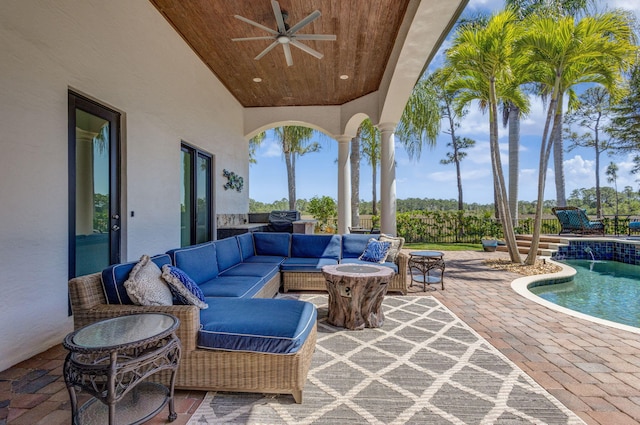 view of patio / terrace with an outdoor pool, an outdoor hangout area, and a ceiling fan