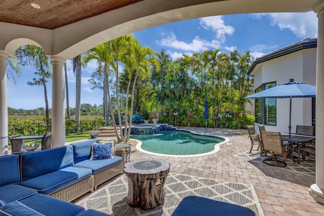 exterior space featuring an outdoor hangout area, a pool with connected hot tub, outdoor dining area, and a patio