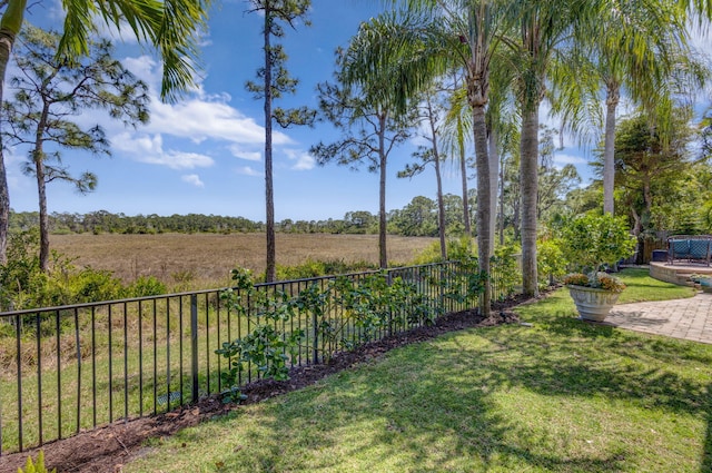 view of yard with a rural view and fence