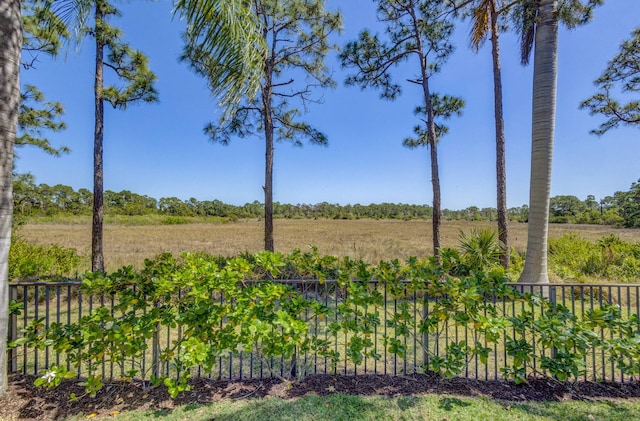 view of yard featuring a rural view and fence